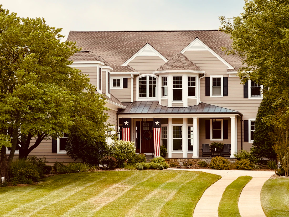 A large family home with a manicured front lawn